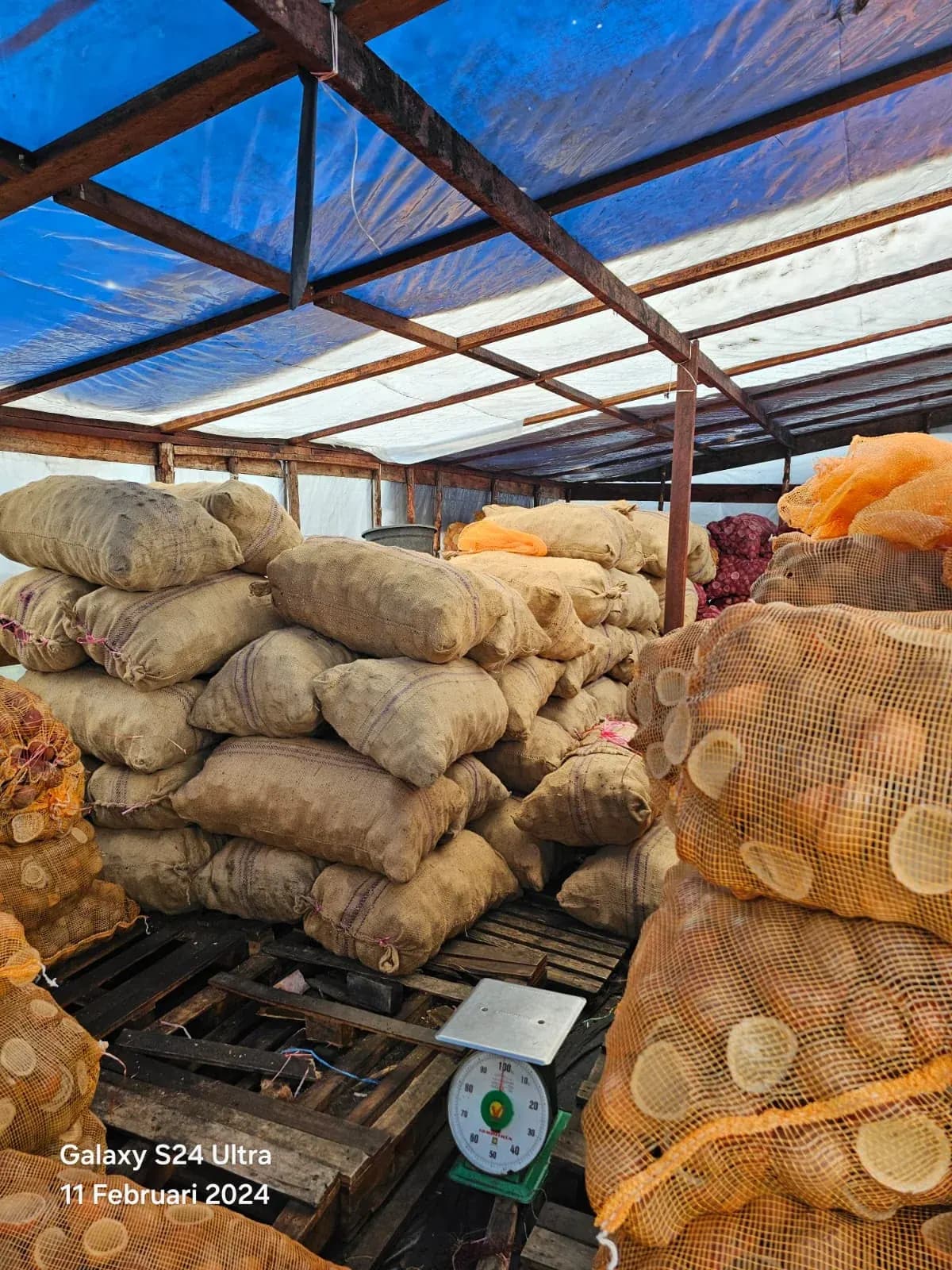 Bags and crates stored under the warehouse roof
