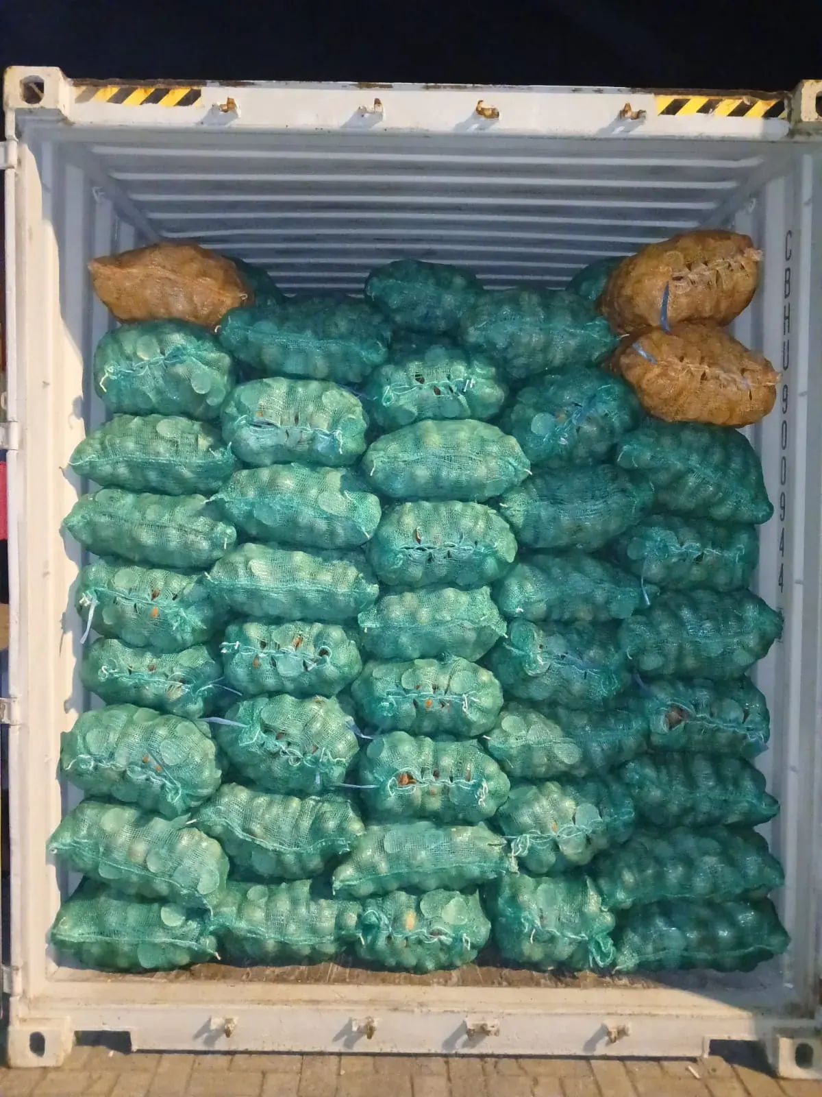 Bags stacked across the open container entrance